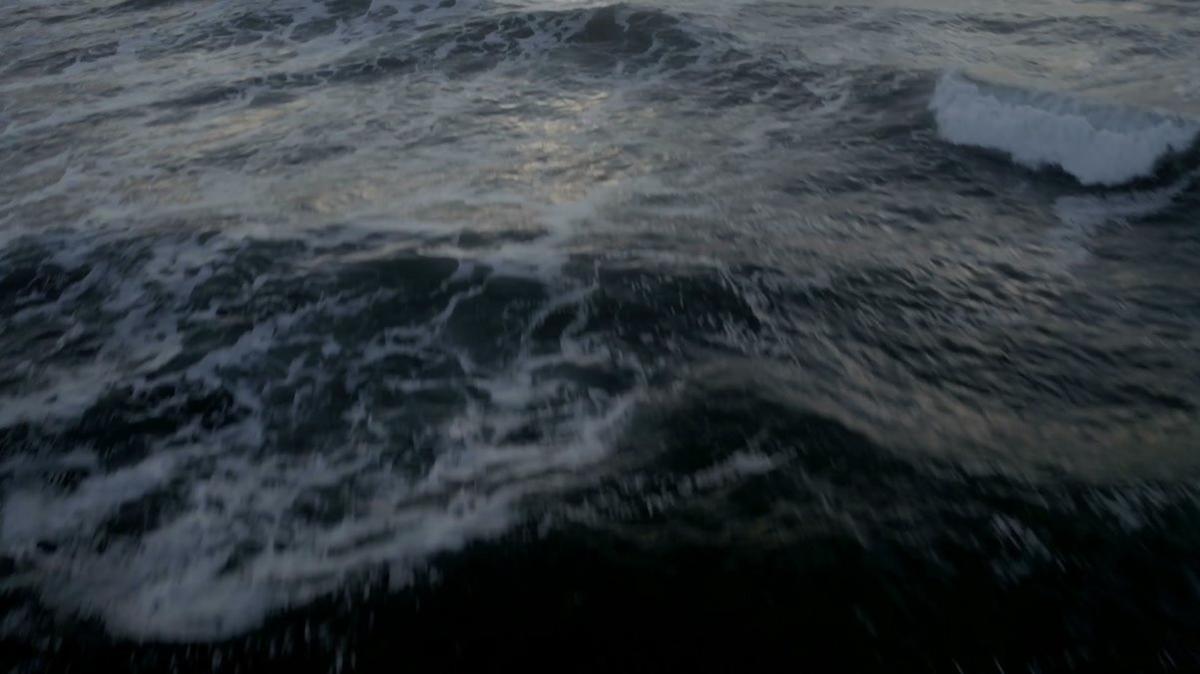 aerial shot open sea lit by the sun