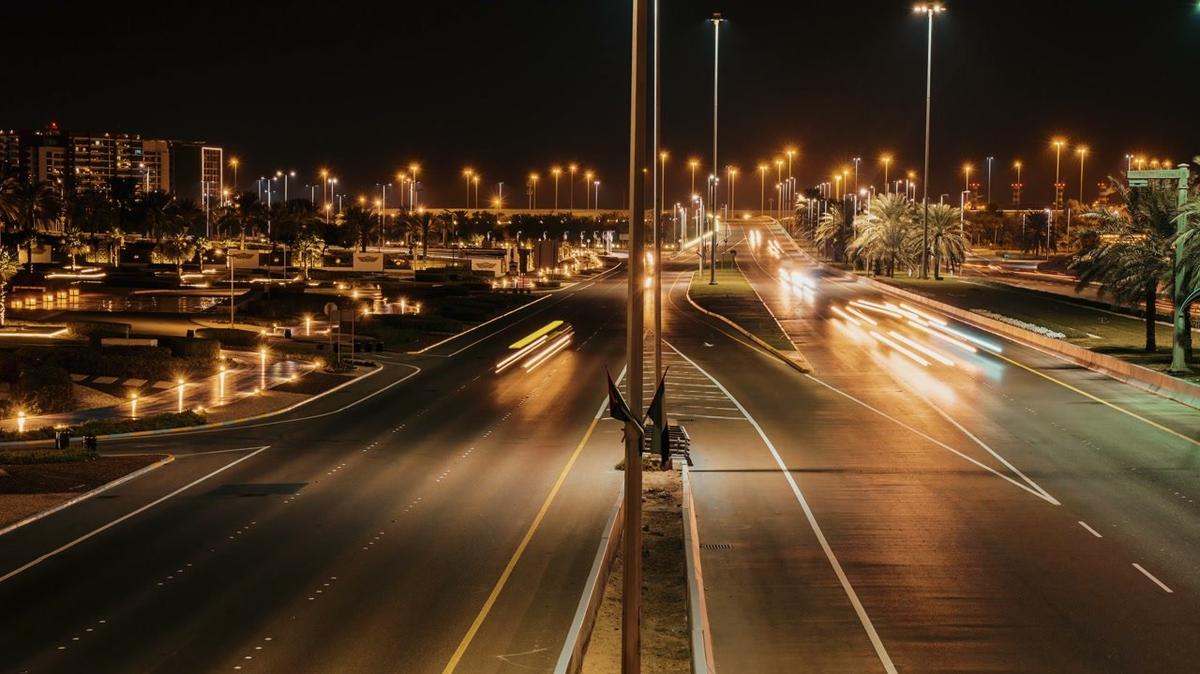 abu dhabi traffic rushing through the night streets