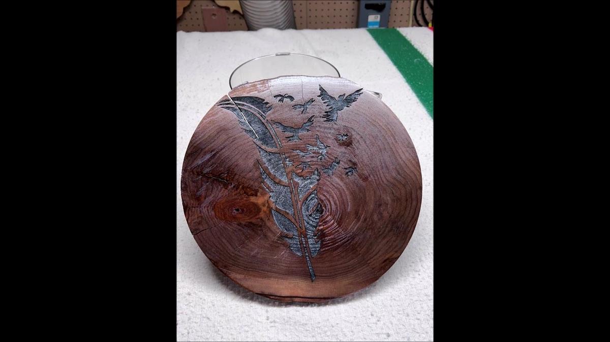 this is a feather engraved in black walnut