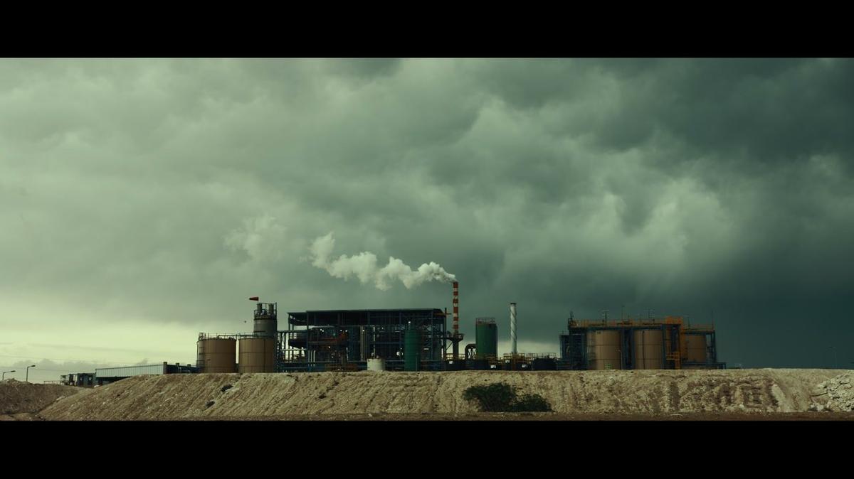 Industrial factory surrounded by dark clouds