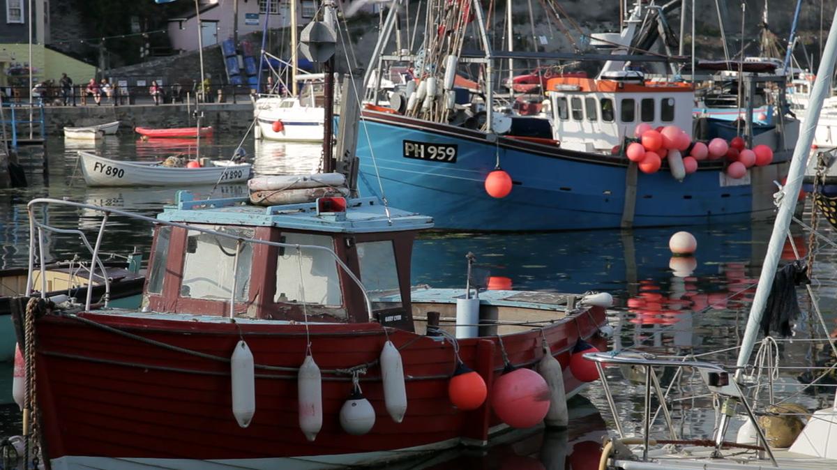 fishing boats moored in harbour cornwall uk