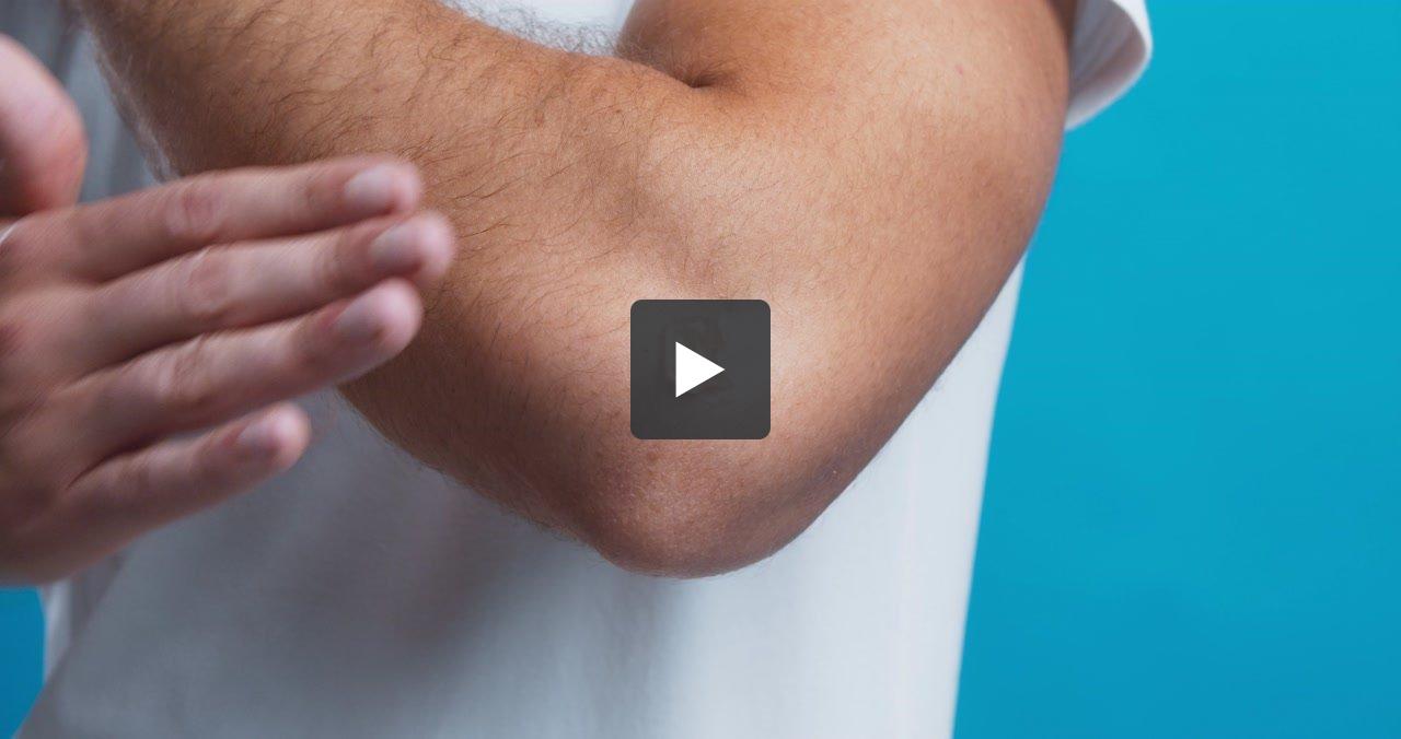 Man with elbow pain getting therapy massage with medicinal gel