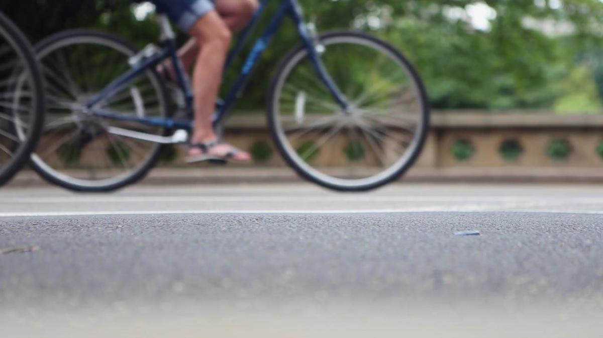 Bikers and Carriages Driving on Street