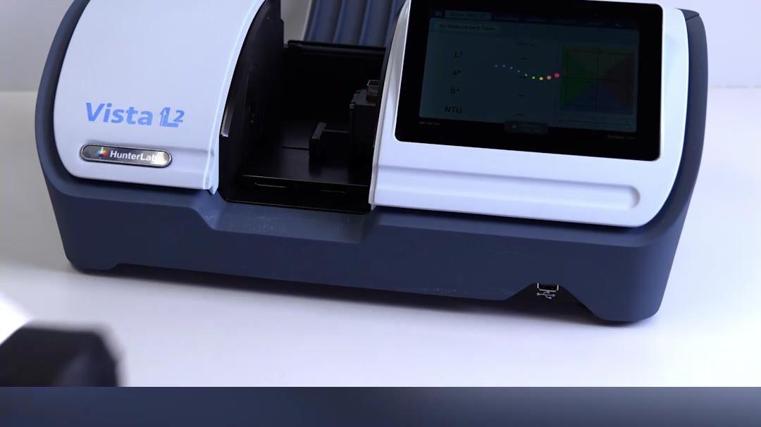 Which transmission spectrophotometer measures color and haze simultaneously?