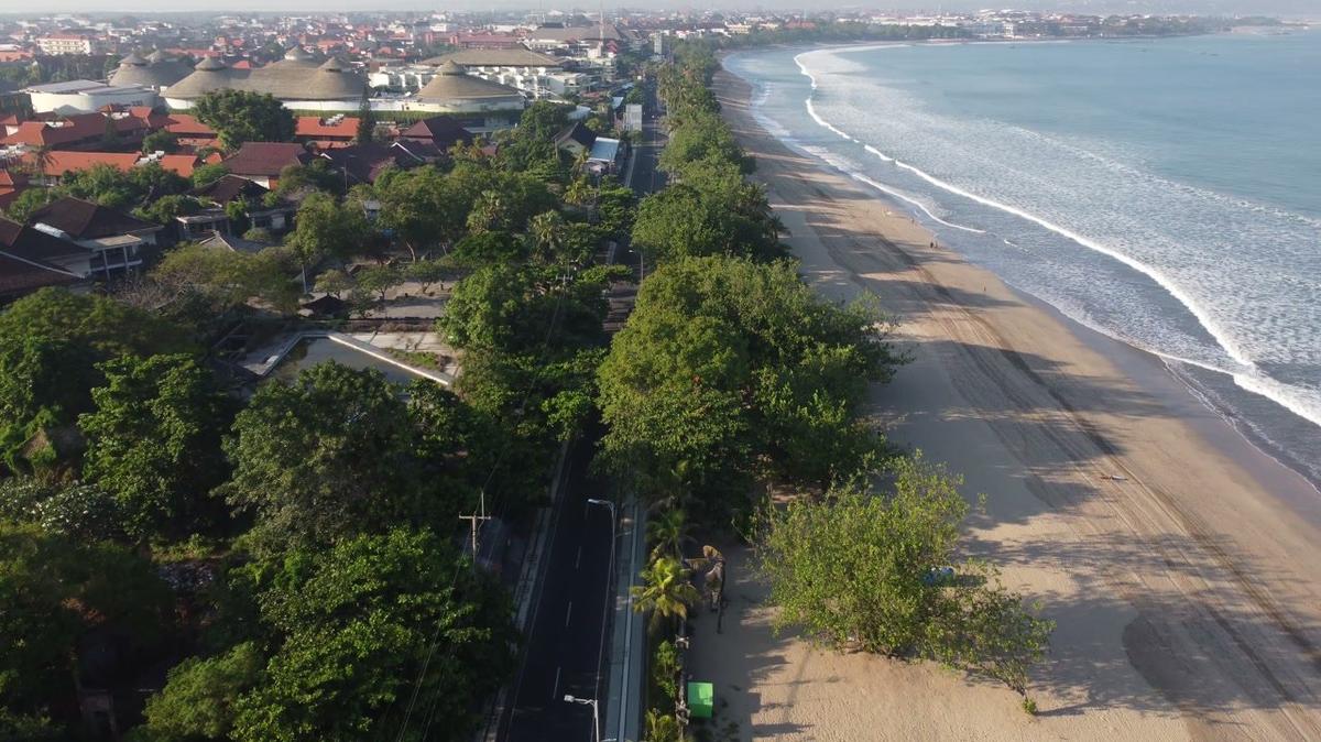 bali indonesia aerial drone view of empty deserted kuta beach street tourist area
