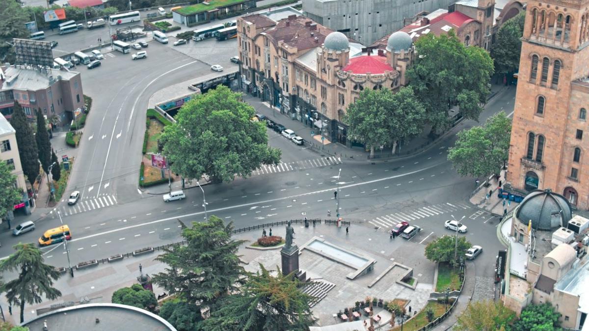 Cars driving on the road in the city aerial